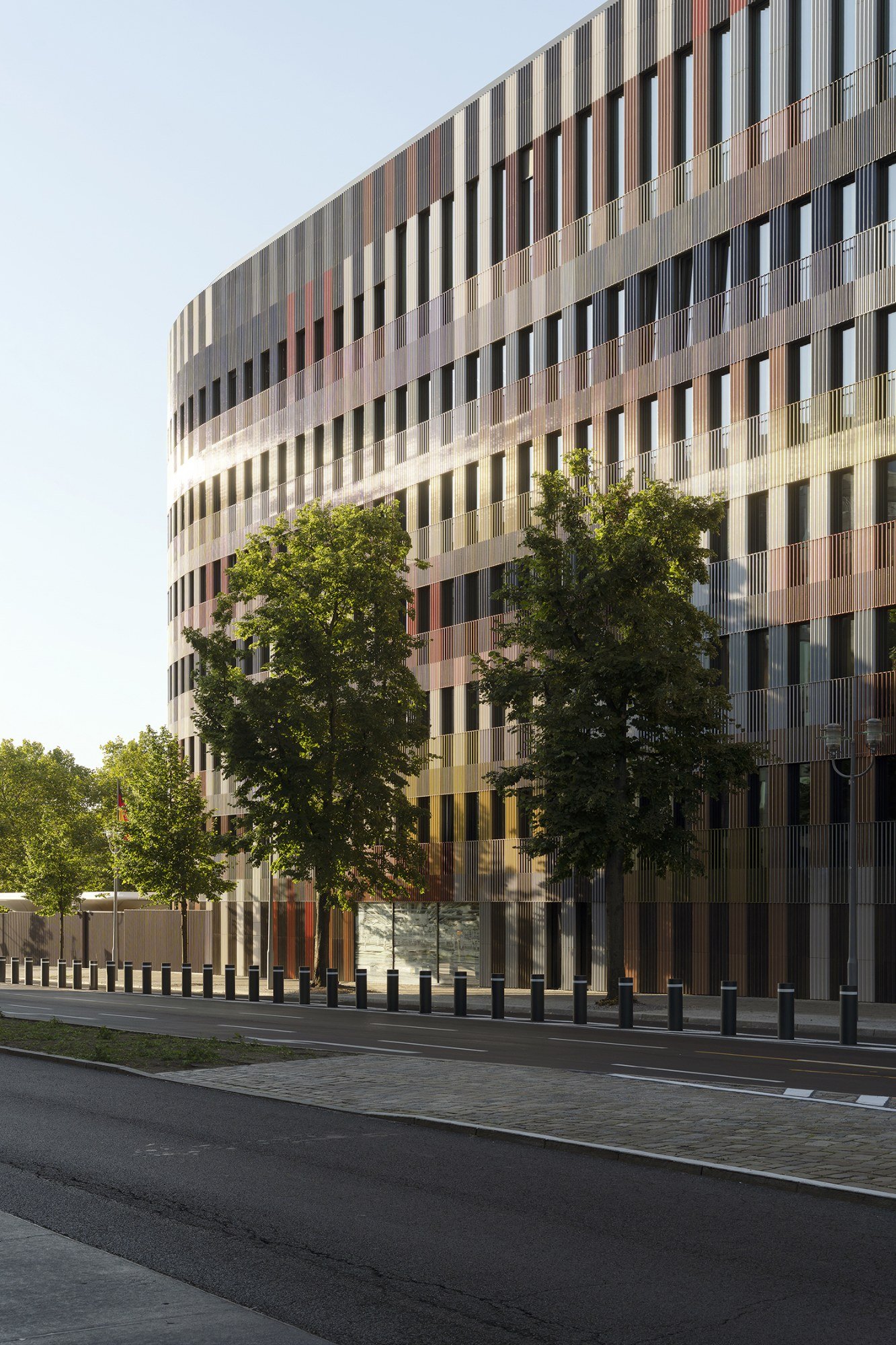 The street frontage combines a regular window rhythm with coloured layers.