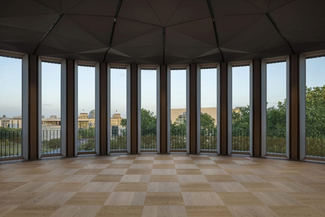 Tall glazing frames views towards Berlin&rsquo;s government district.