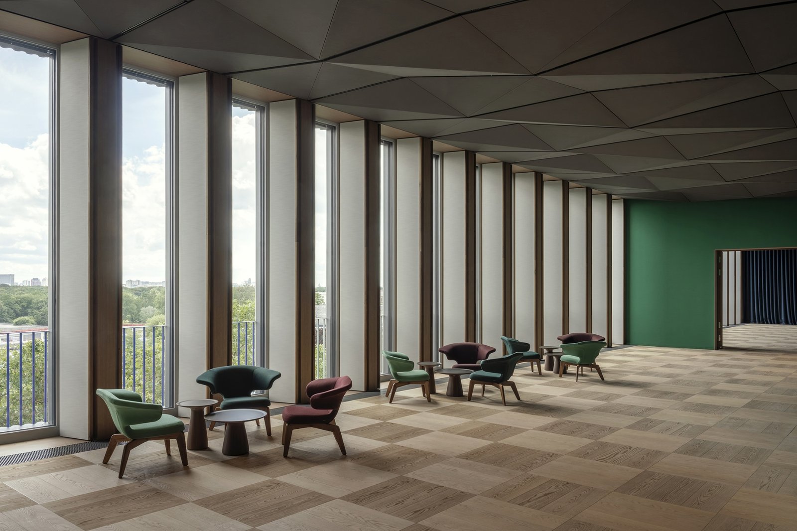 Small seating groups occupy the edge of the larger reception space.