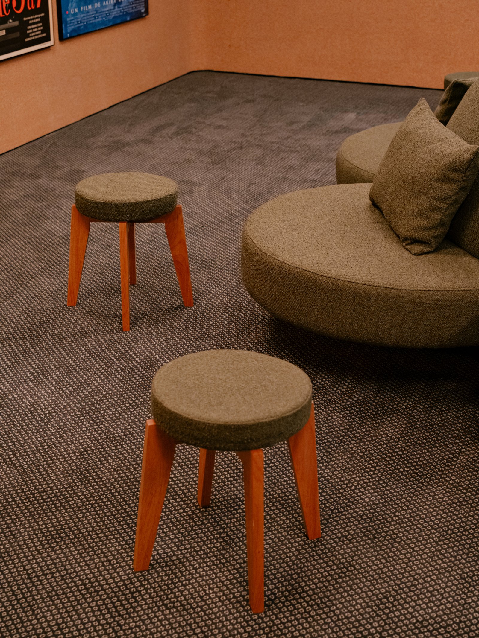 Small stools and curved upholstery in the waiting area