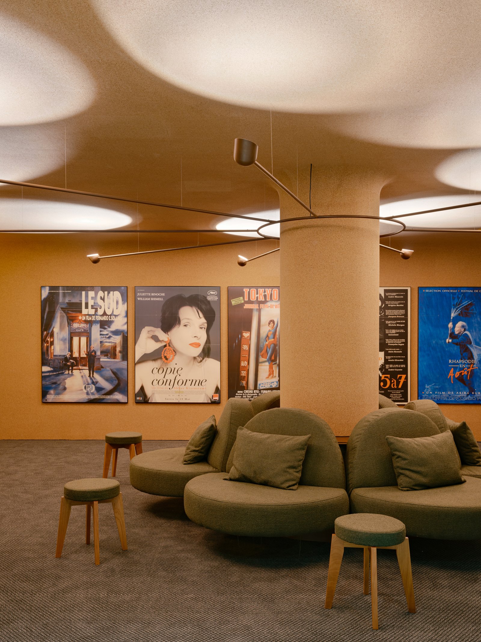 Circular seating and a branching light fixture around the column