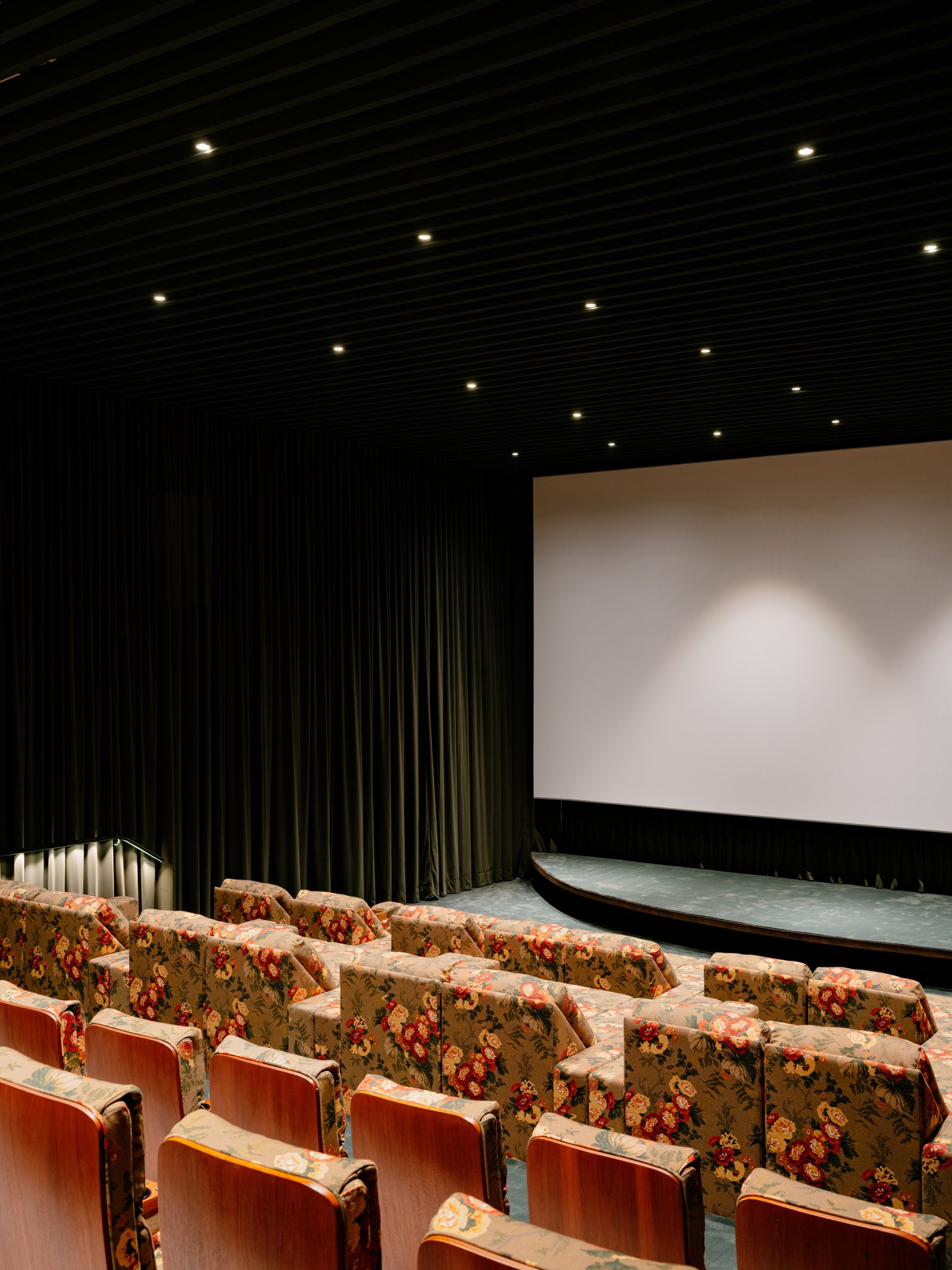 The screen and curved stage seen from the seating rows