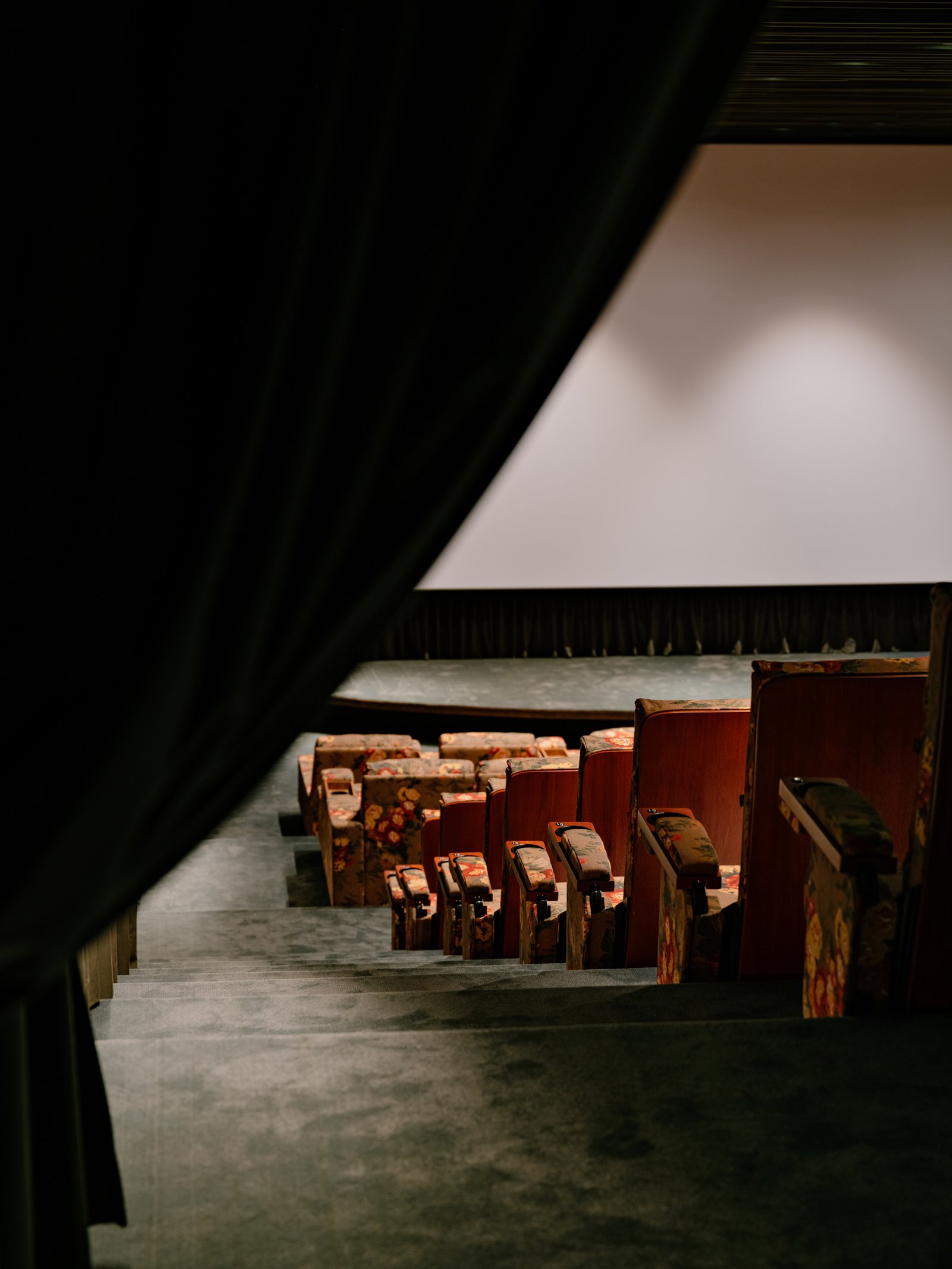 A curtain frames the entrance to the screening room