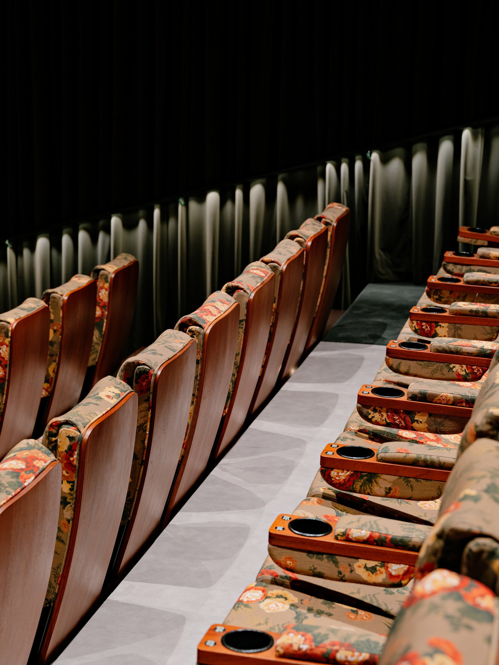Timber seat backs and cup holders along the stepped rows