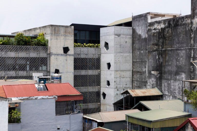 Concrete Flakes office extension among neighboring rooftops in Hanoi