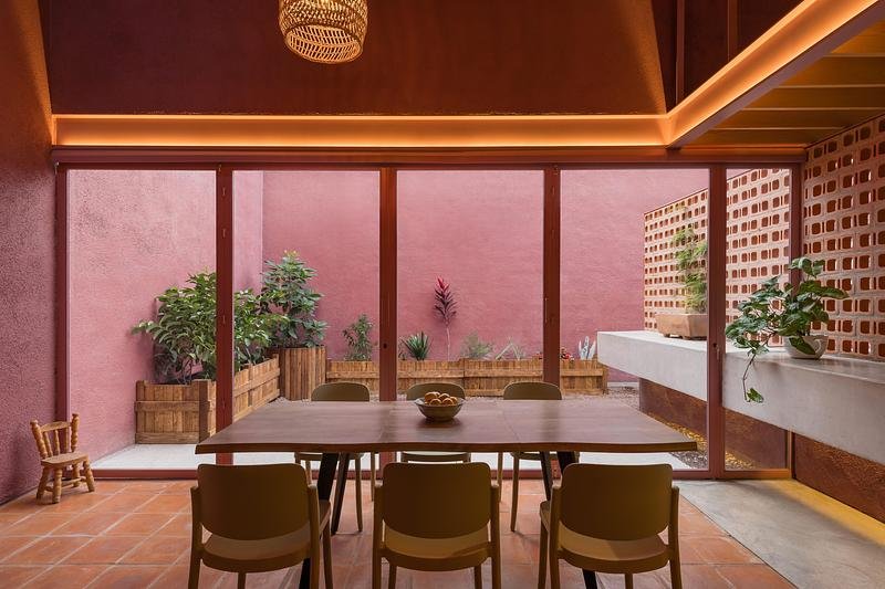 A continuous light line marks the edge above the courtyard glazing