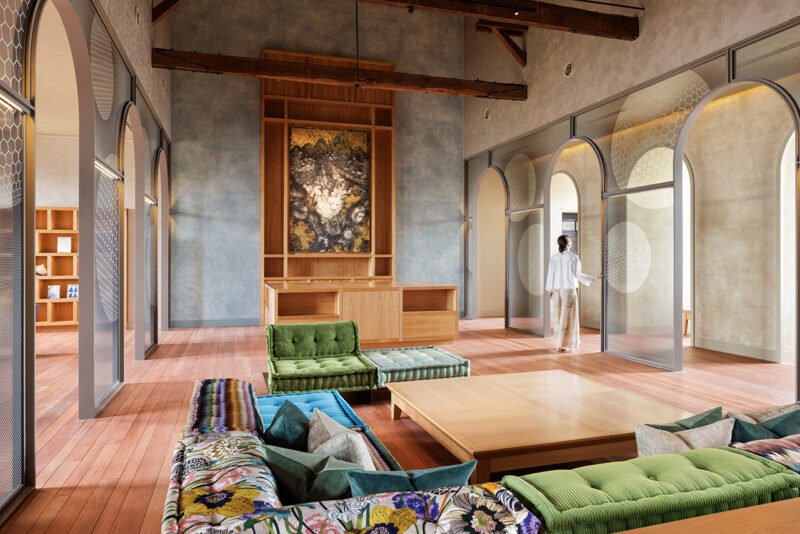 Seating group within the main lounge beside tall arches and windows