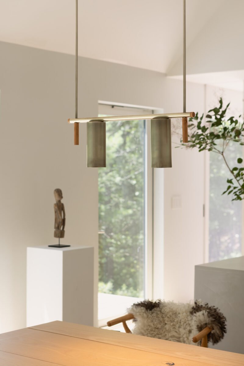 Touch pendant: two cylindrical heads above a dining table
