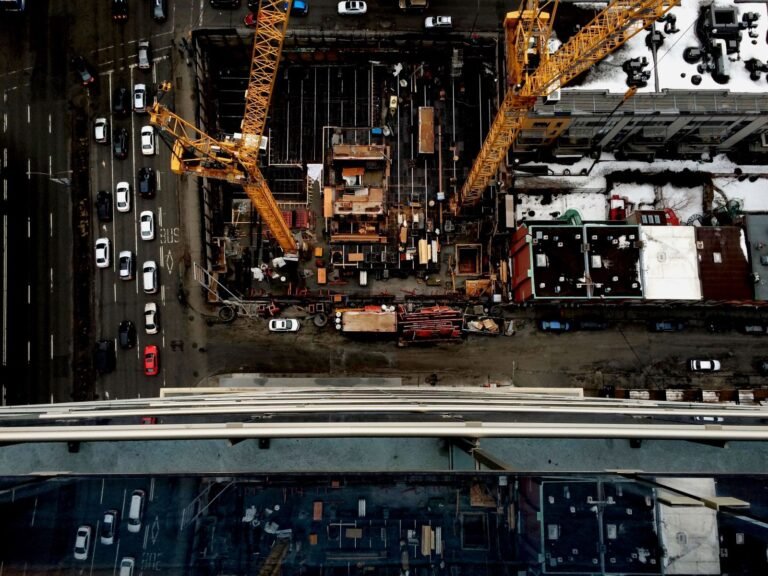 Elevated view of a construction site with tower cranes and surrounding buildings in Montreal, Canada.