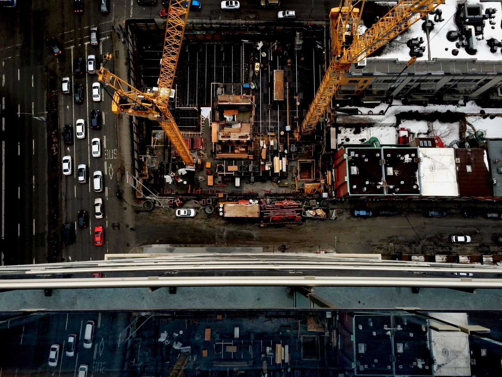 Elevated view of a construction site with tower cranes and surrounding buildings in Montreal, Canada.