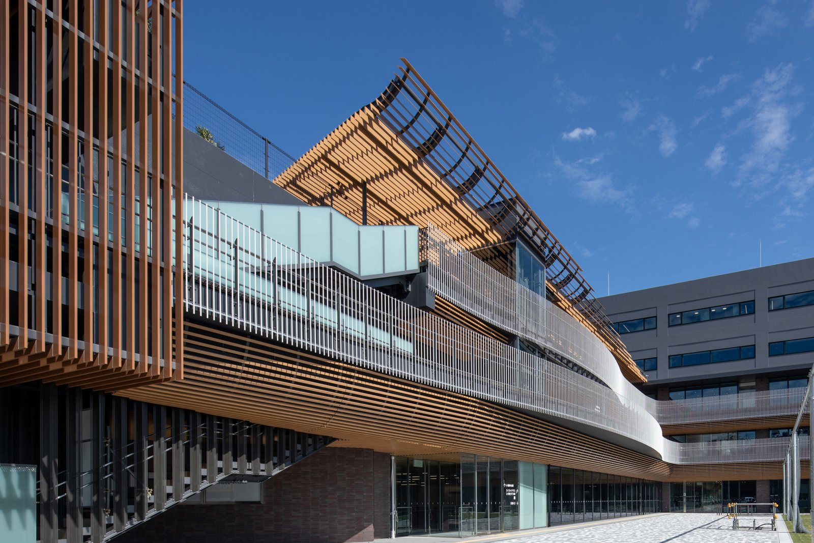 Curved public edge beneath the elevated roof