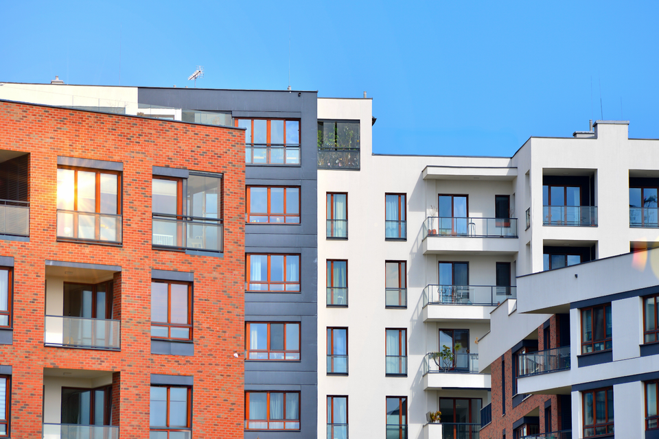 Apartment buildings and communal landscaping in the official UK building safety announcement; contextual photograph.