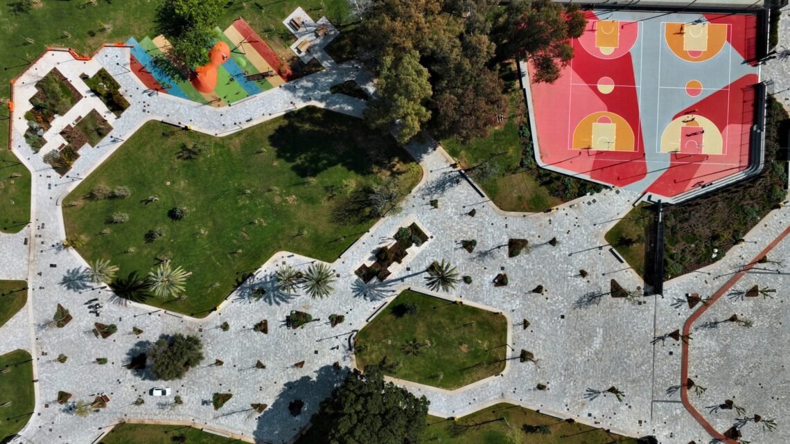Aerial view linking paths, lawns and sports areas.