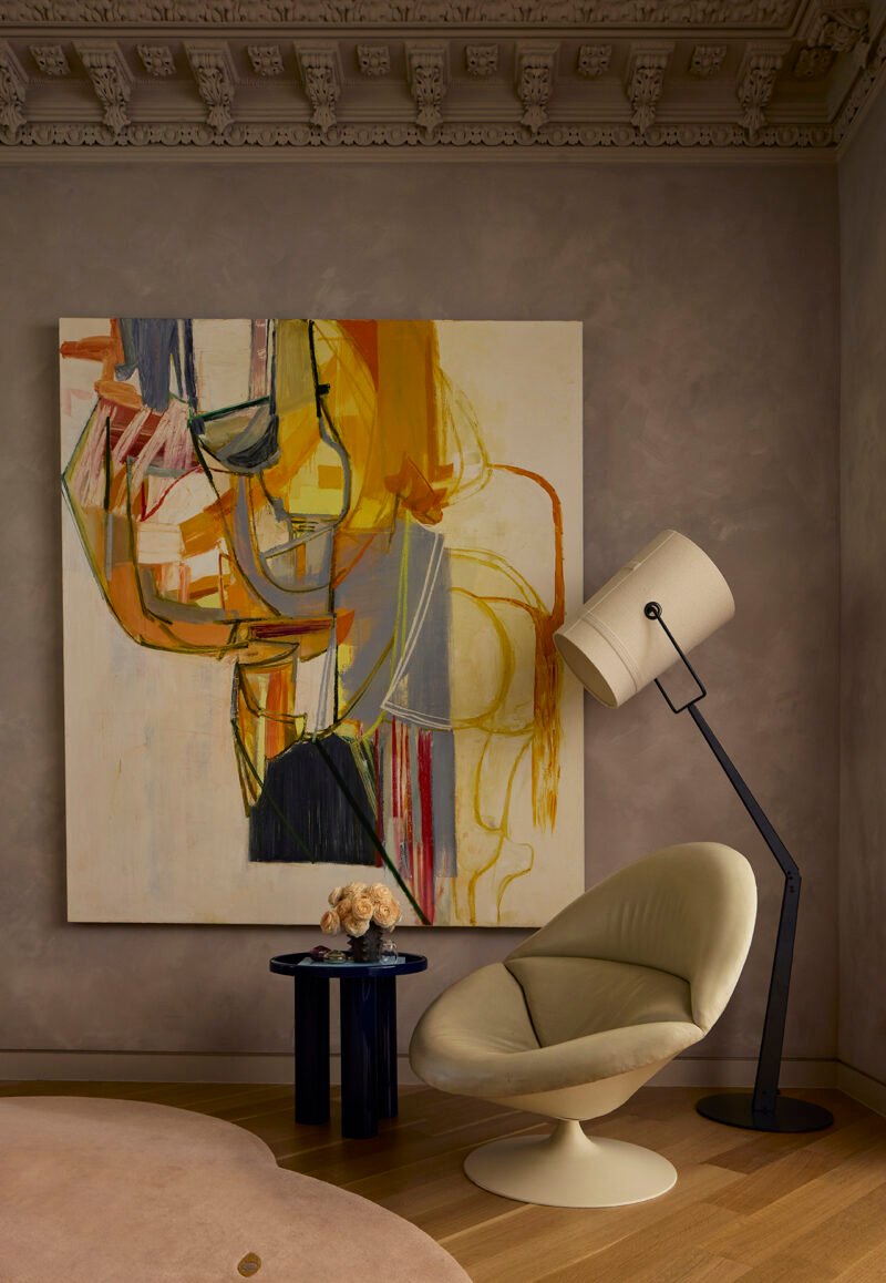 A separate chair and side table create a smaller place to pause beside an artwork.