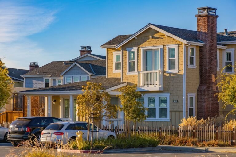 Suburban houses with brick and siding fa&ccedil;ades, driveways and parked cars in the United States.