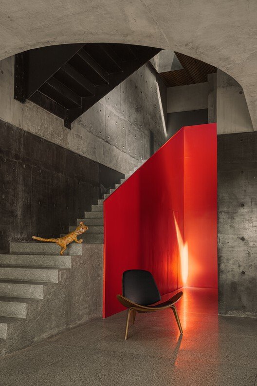 Concrete and spiral stairs connecting the contrasting levels of Terra Pavilion