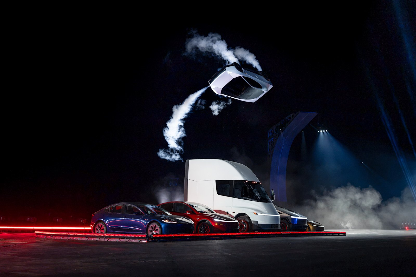 Tesla Roadster performing an airborne manoeuvre above parked vehicles during its unveiling. Courtesy of Tesla, Inc.