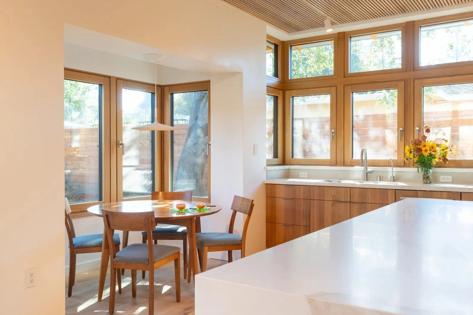 Timber tilt-and-turn windows around a kitchen and breakfast nook at Cereza by Arkin Tilt