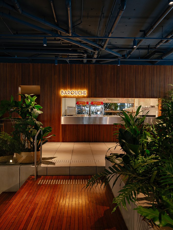 The café counter beneath exposed blue services