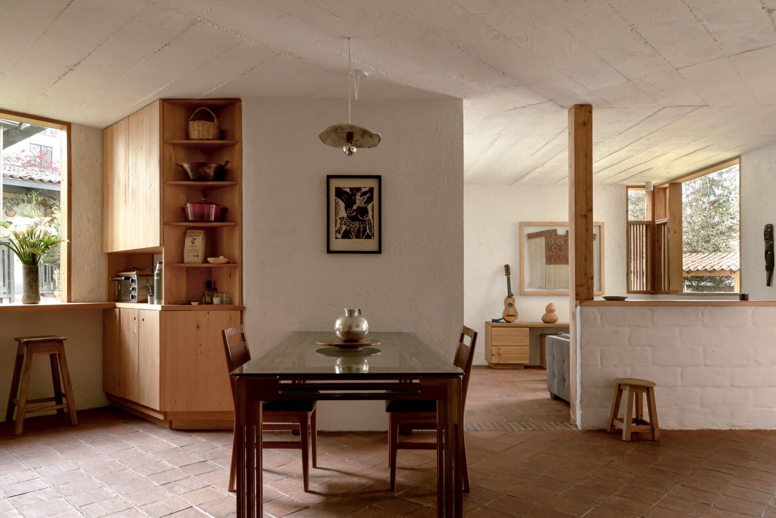 The dining table occupies the transition between the kitchen and living area.