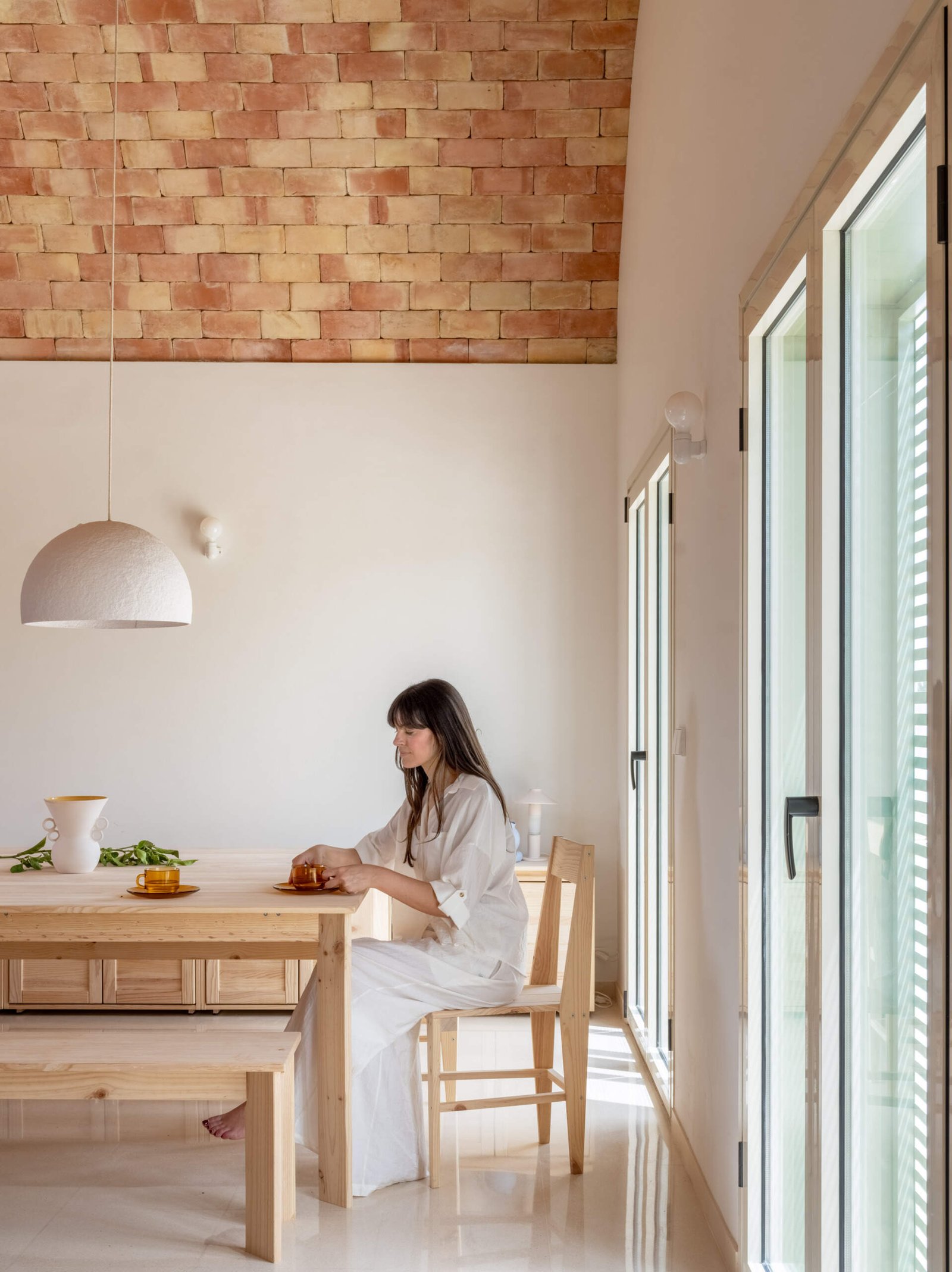 The timber table sits beside the terrace doors.