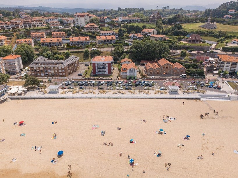 Comillas seafront promenade with sand, coastal planting and pedestrian paving