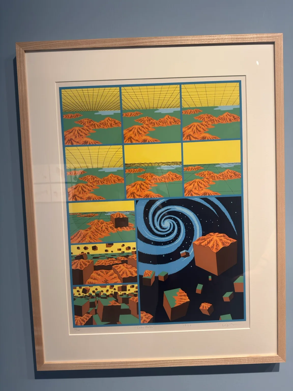 A framed colourful artwork combining repeated landscape panels, geometric forms and a spiral motif at Hayy Jameel.