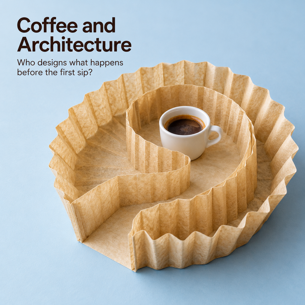 Editorial composition of a white coffee cup surrounded by curved, pleated filter-paper walls on a pale blue background.