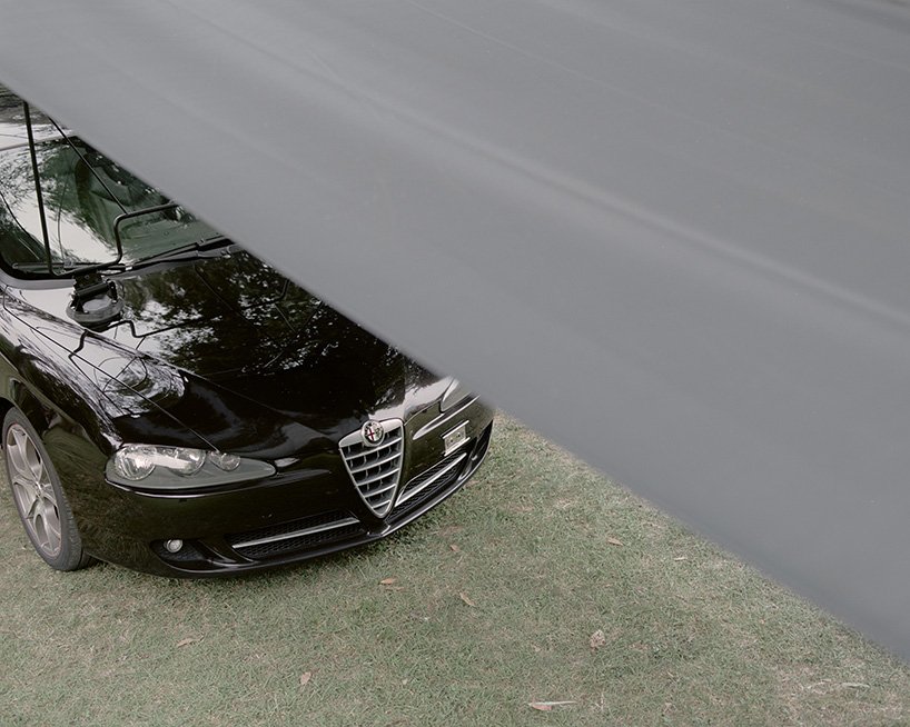 The car body remains recognizable beneath the spanning sheet.