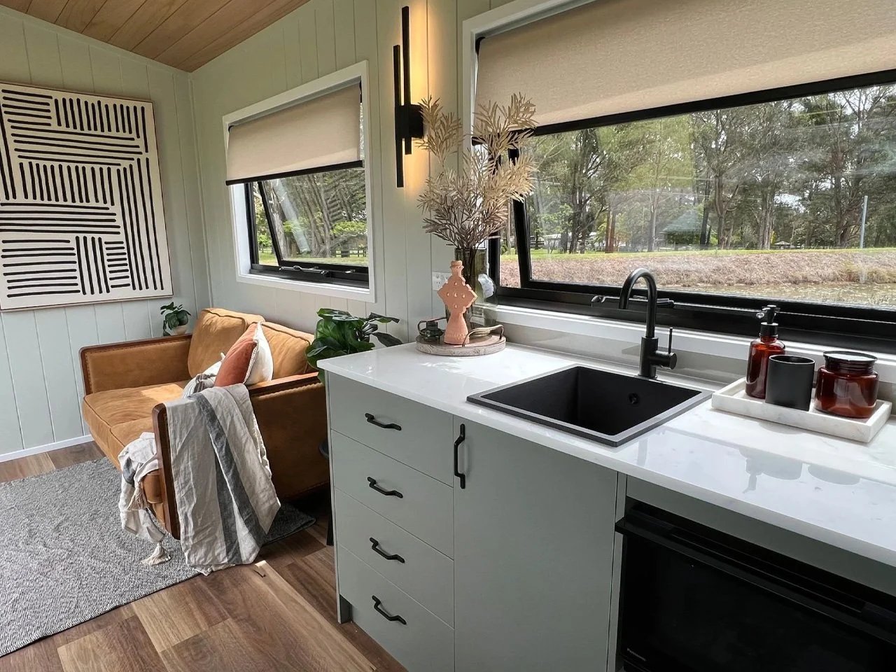 Kitchen sink and pale green drawers below a horizontal window