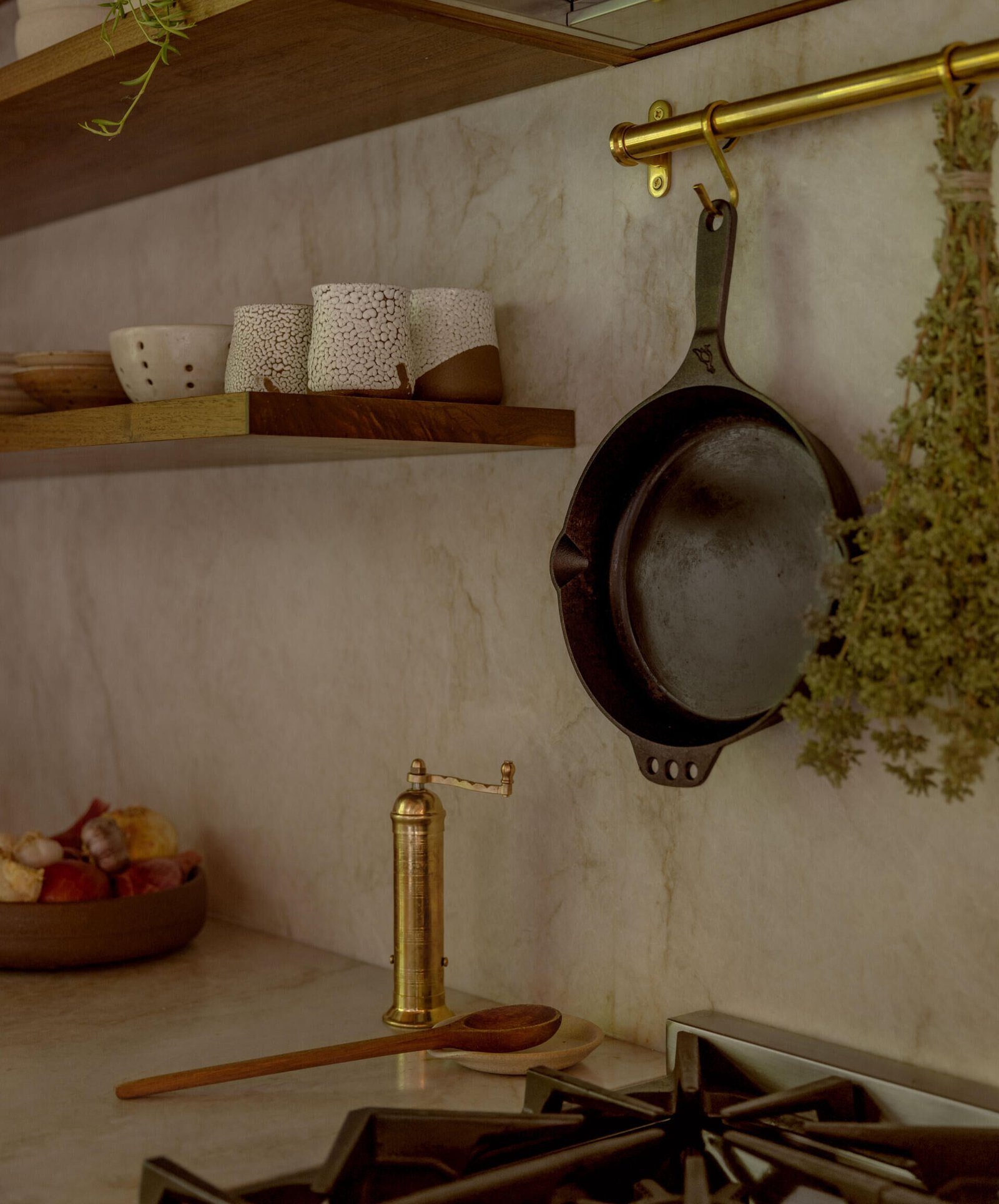 Hanging utensils and open shelves keep everyday objects visible