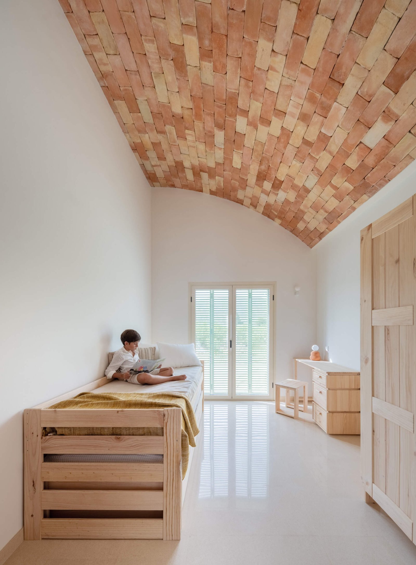 A desk and single bed share the smaller bedroom.