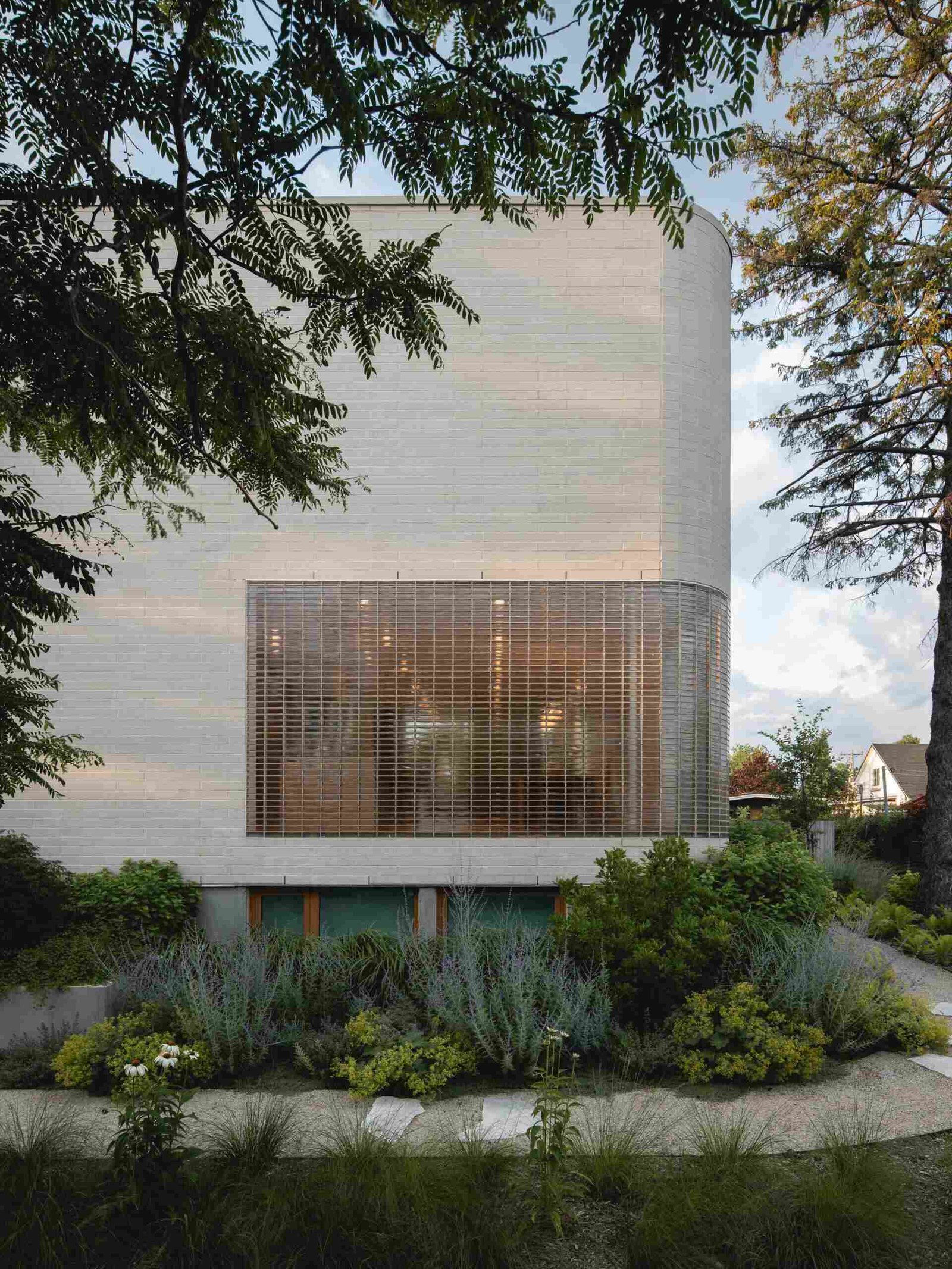The glass-brick opening occupies the lower part of the largely solid facade.