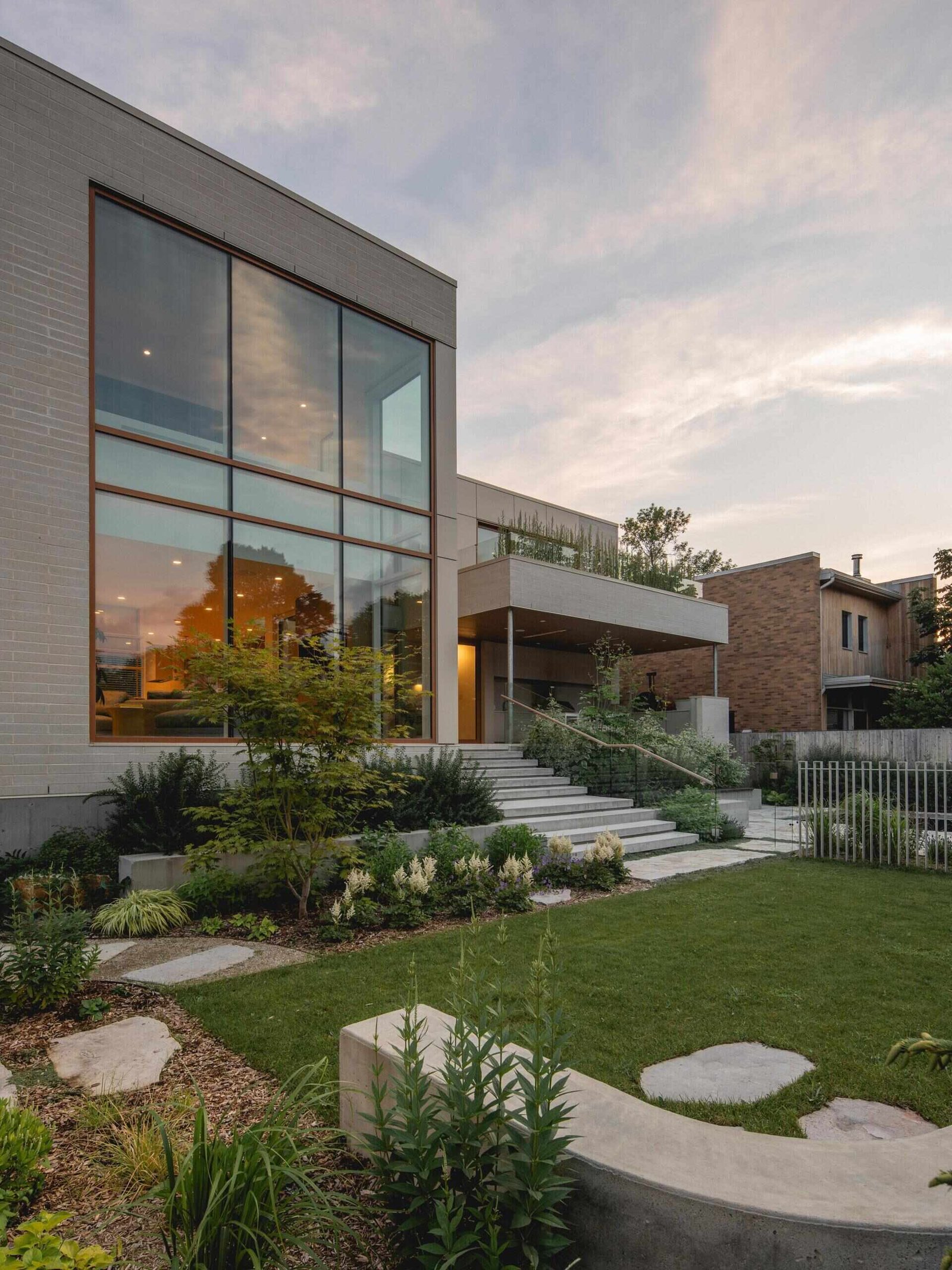Broad steps connect the main living level to the garden.