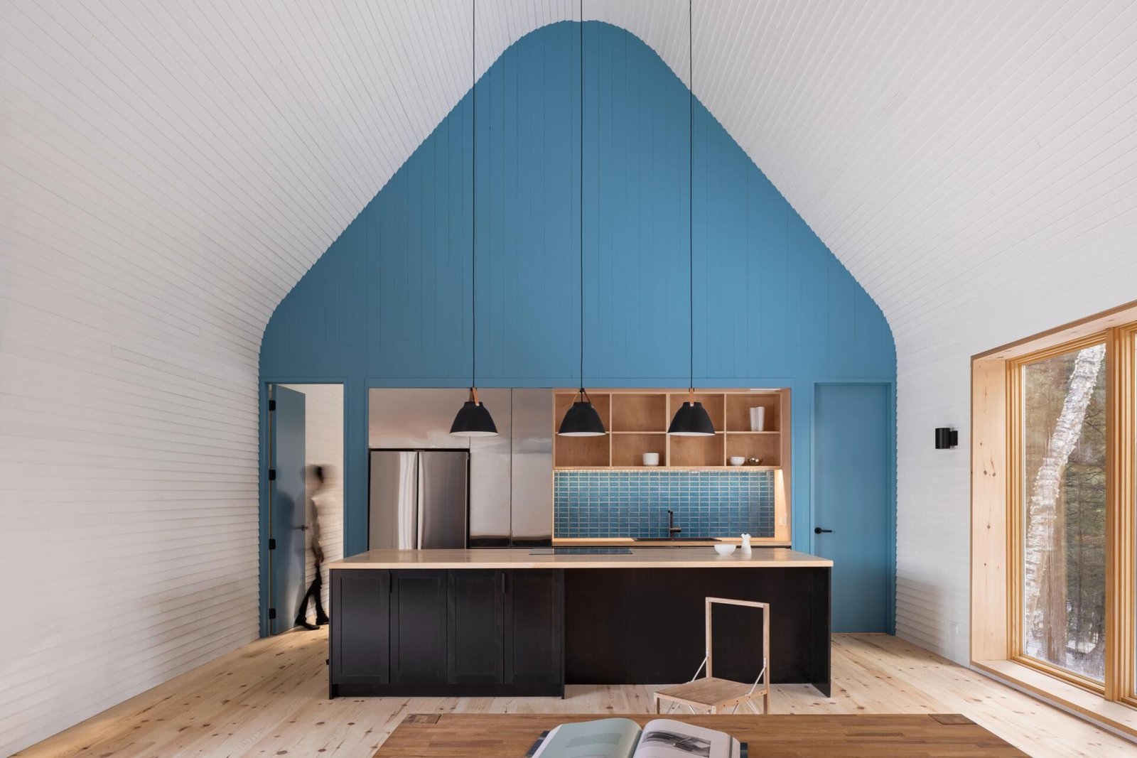 Blue gable wall and timber cabinetry in the cottage kitchen