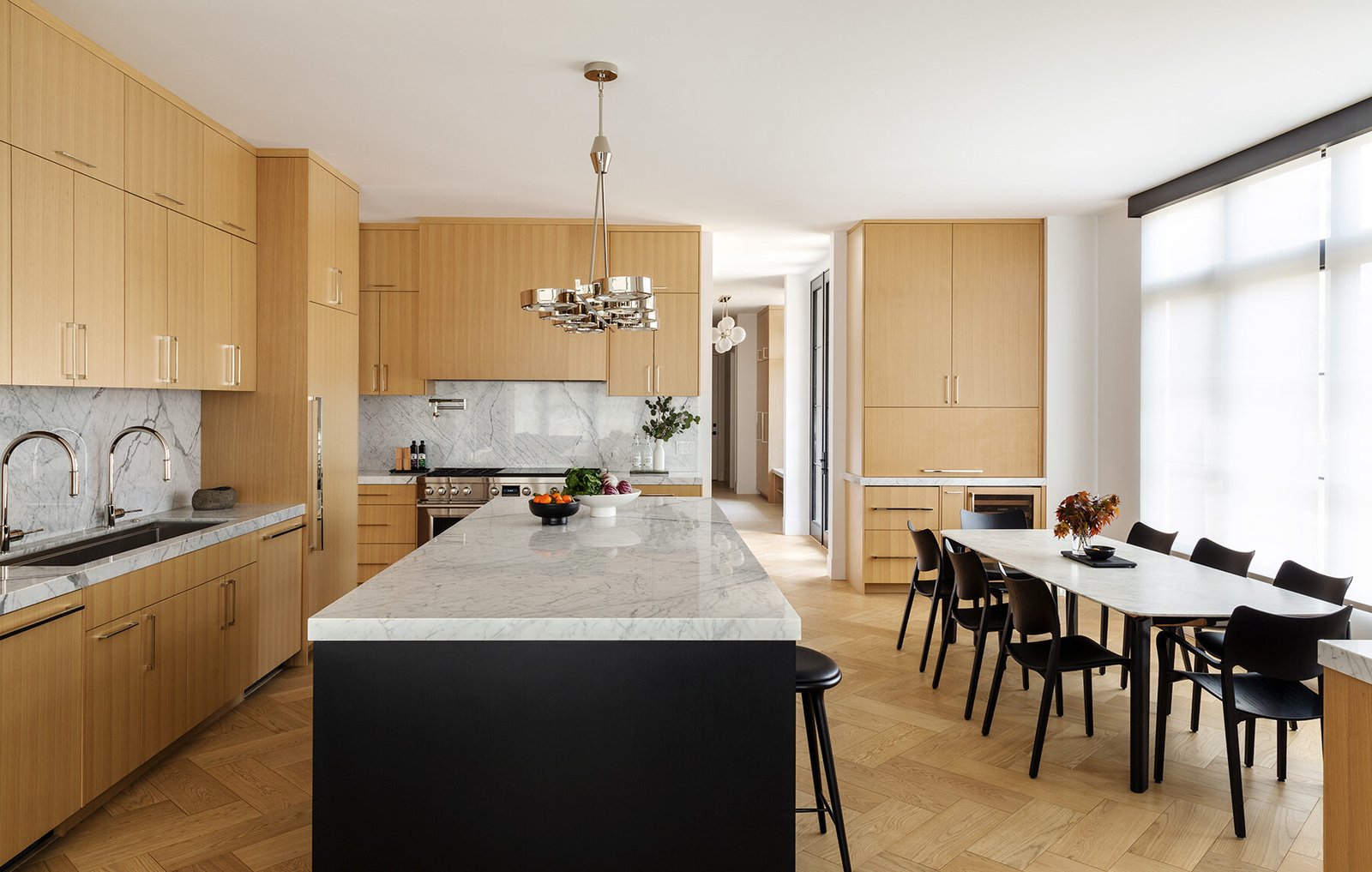 Pale kitchen cabinetry contrasts with the dark central island.
