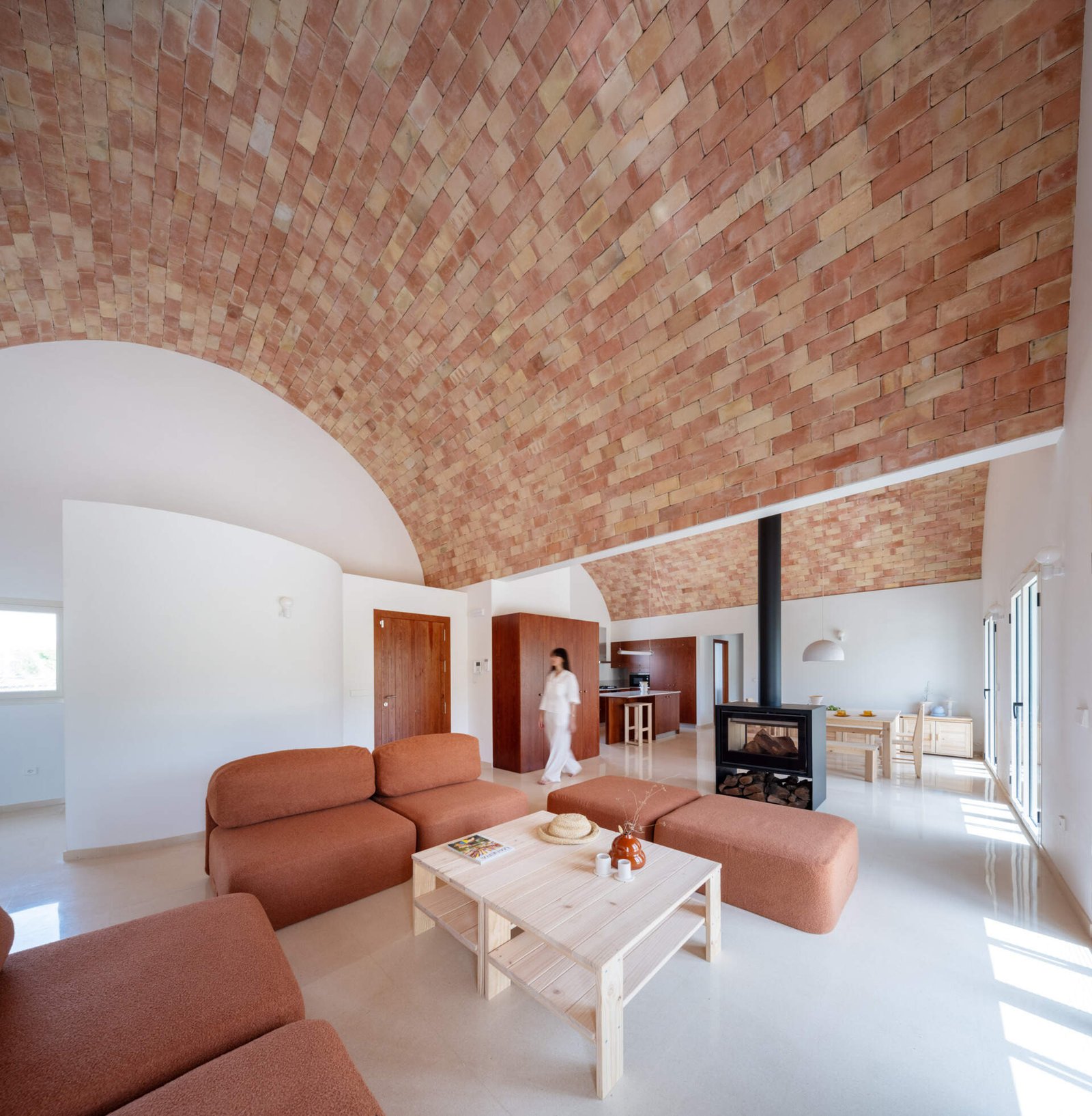 The fireplace marks the transition between living and dining.