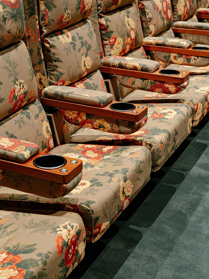 Floral seat fabric, timber arms and integrated cup holders
