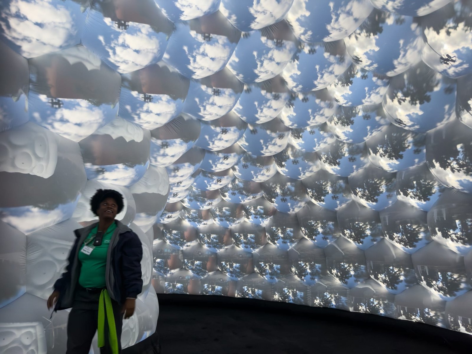 A visitor encounters projected views across the inflatable interior.