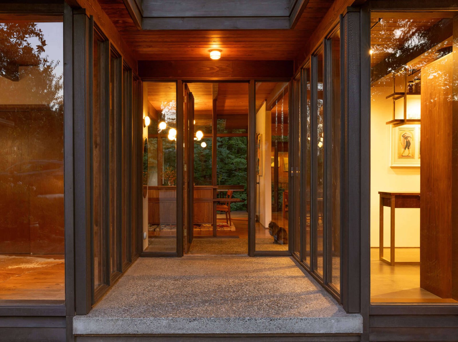 Glazing lines the sheltered approach to the front door