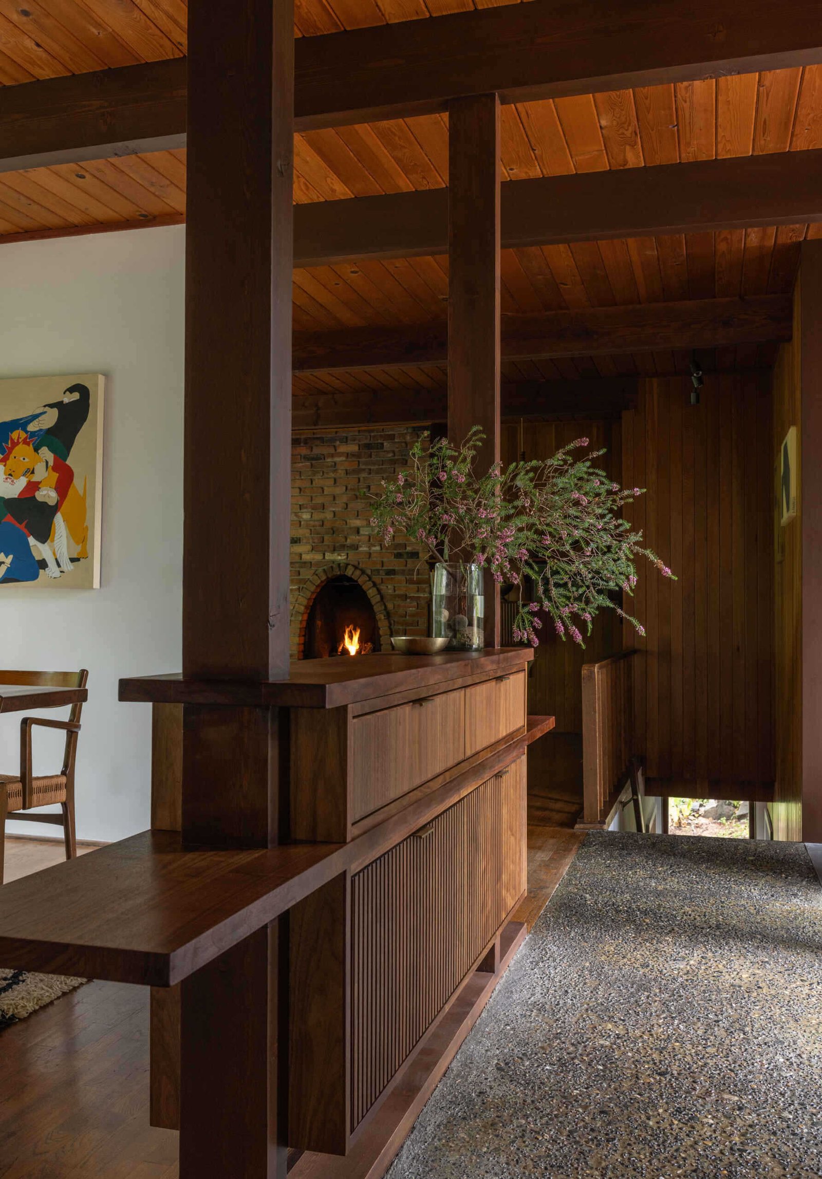 A walnut divider defines the entrance without closing the view