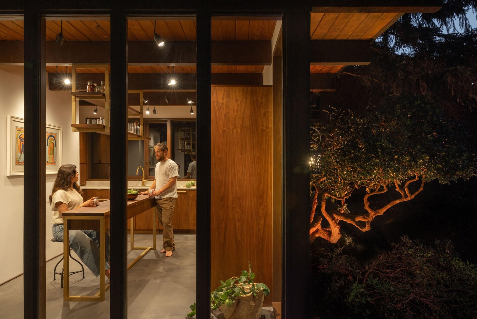 The kitchen in use, seen from outside after dark