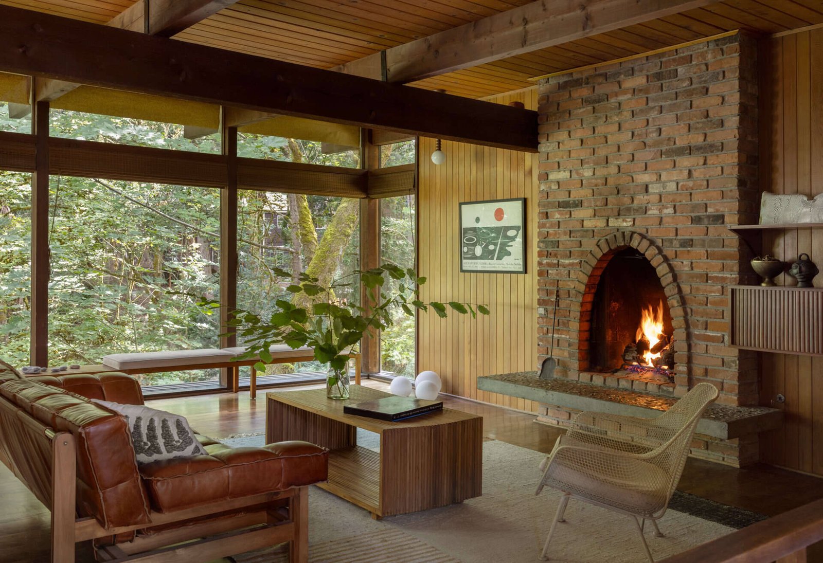The retained arched brick fireplace anchors the living room